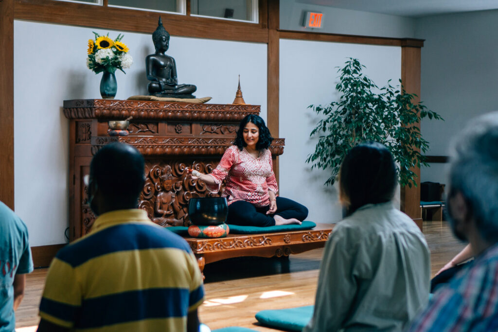 teacher and students in meditation hall